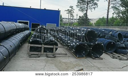 Warehouse Of Finished Plastic Pipes Industrial Outdoors Storage Site. Manufacture Of Plastic Water P