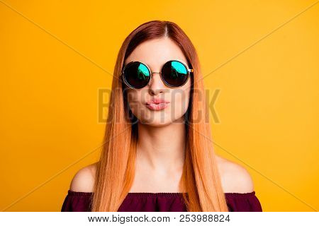 Portrait Of Red Straight-haired Attractive Cute Nice Young Girl, Wearing Sun Glasses, Blowing With P