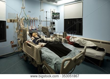 Tired Father Sleeping Next To Unconscious Disabled Teen Son In Hospital Bed At Night. Child Has Brea