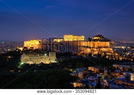 Famous greek tourist landmark - the iconic Parthenon Temple at the Acropolis of Athens as seen from Philopappos Hill in the evening blue hour, Athens, Greece