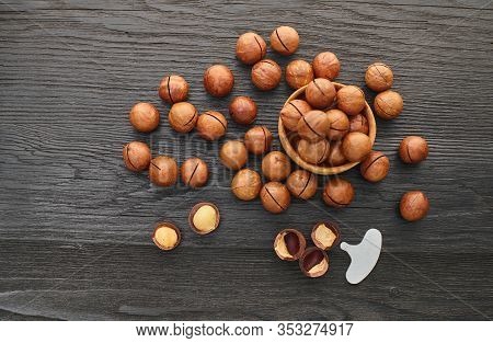 Macadam Nut Close-up On A Black Wooden Background