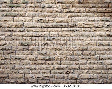 A Full Frame Image Of An Old Yellow Sandstone Wall Made Of Regular Blocks