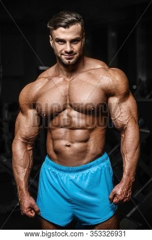 Good Looking Fitness Man Pumping Up Muscles