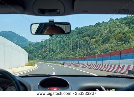 Driving A Car On A Asphalt Highway Through A Gorge
