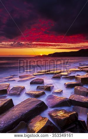 The Sky Clears After A Rain Storm Just Long Enough To Show The Deep Red And Purple Clouds Over The S