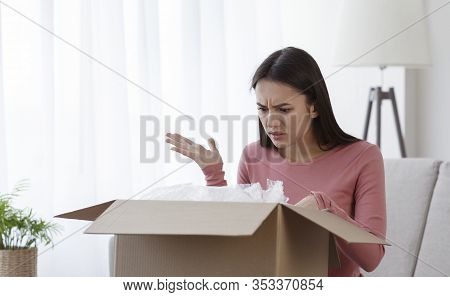 Disappointed Young Girl Consumer Having Problems With Bad Shopping Order, Displeased By Post Shippin