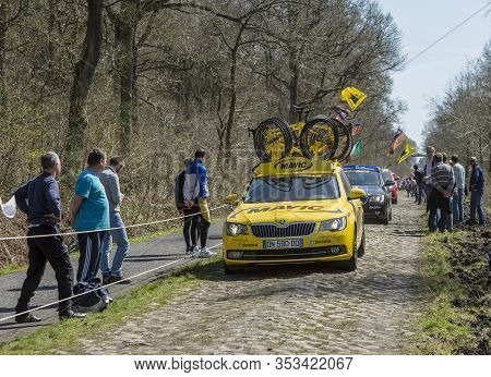 Wallers,france - April 12,2015: The Yellow Technical Car Of Mavic Driving On A Cobblestone Road Duri