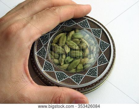 Mashhad, Iran, 01 03 2020: Green Cardamom Pods Into Handcraft Box. Hand On Box. Close Up.