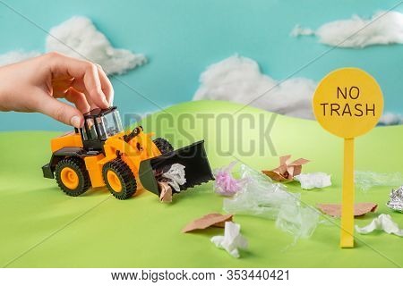 Kid Playing With A Toy Truck That Collects Trash From Lawn