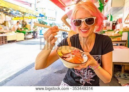 Caucasian Lifestyle Happy Tourist Woman Eats With Chopsticks, Sashimi Salad At Ameya-yokocho Market 