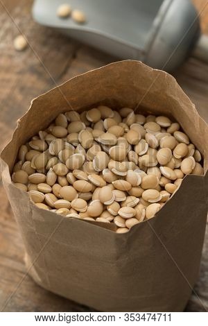 Paper sack with dried raw Hyacinth beans close up