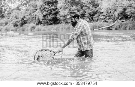 Hooked Up Sportfishing. Mature Man Fly Fishing. Man Catching Fish. Summer Weekend. Big Game Fishing.