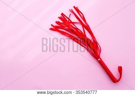 Leather Red Whip On A Pink Background. Sex Toy. Flat Lay, Copy Space.