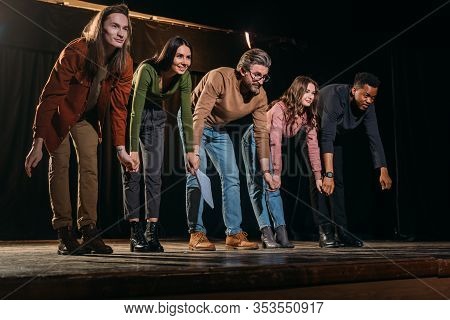 Happy Actors And Actresses Bowing On Stage