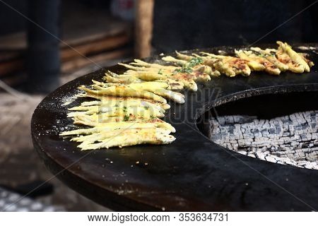 On A Brazier, Original In A Form, From Thick Metal The Small Fish Rolled In Flour Is Baked.