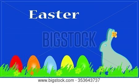 Multi-colored Easter Eggs On The Grass On A Blue Easter Background And A Rabbit. Hare. Easter Greeti