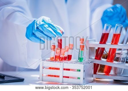 Asian Scientist Working In Science And Chemical For Health. Doctor With Virus In Lap Test To Protect