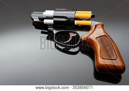 Dangerous Short Revolver With Cigarettes As Bullets On Shiny Surface
