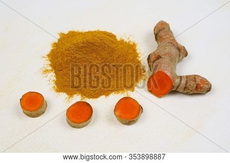 Turmeric Powder And Fresh Turmeric Roots Isolated On A White Background Are Used As An Ingredient In