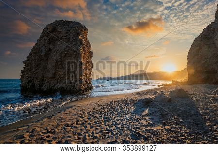 Fyriplaka beach and waves of Aegean sea on sunset, Milos island, Cyclades, Greece