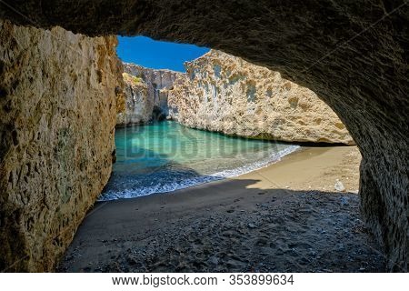 Papafragas hidden beach with crystal clear turquoise water and tunnel rock formations in Milos island, Greece