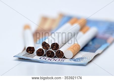 Cigarette With Indonesia Money On White Background Studio Shoot