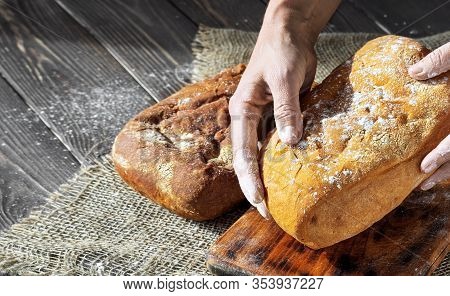 Baker Lays On The Table Freshly Baked Ciabbata Bread. Closeup, Copy Space. Shallow Depth Of Field.