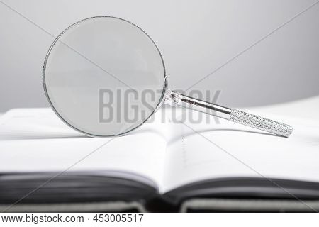 Magnifying Glass At Notebook, Organizer. Schedule, Agenda Analysis, Time Management Concept. High Qu