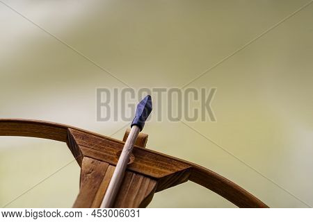Toy Crossbow Arrow With Rubber Finisher Lies In The Bed Of The Crossbow.