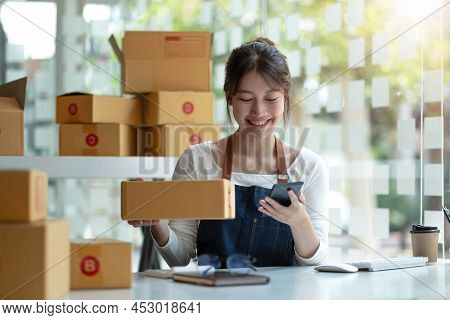 Portrait Of Asian Young Woman Working With A Box At Home The Workplace.start-up Small Business Owner