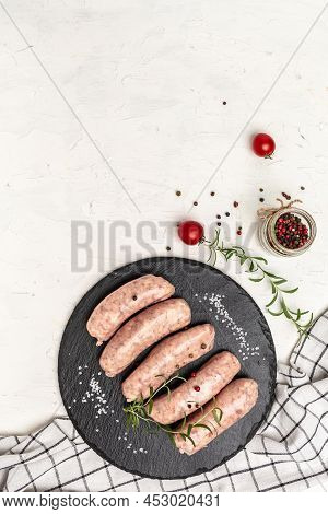Minced Meat Wrapped In Bacon On A Light Background. Chevapchichi Or Kofta Kebab. Raw Sausages Of Gro