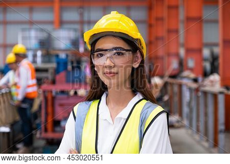 Selective Focus At Young Women Inspector Wearing Safety Equipment. While Doing Audit For Quality And