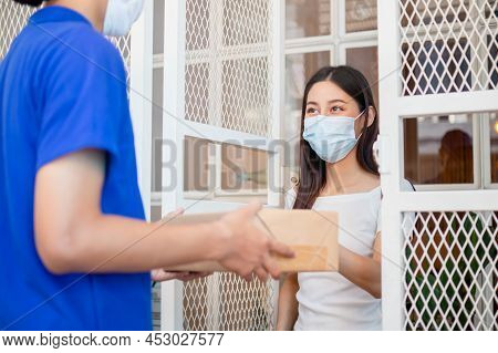Asian Young Woman, Client Received A Delivery Of Cardboard Box, Parcel From Delivery, Postman, Weari