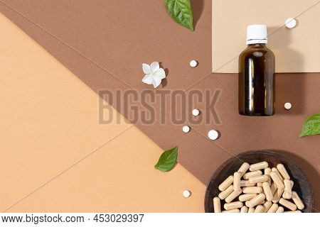Flat Lay Composition Of Various Vitamin Capsules And Dietary Supplements On Brown Background With Co