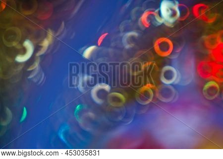 Background - Concentric, Multicolored Lights, On A Blue Background. Ring Bokeh.