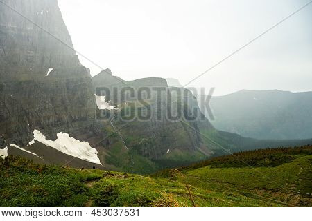 Feather Plume Falls Drops Into The Rainy Valley Below Piegan Pass In Glacier National Park