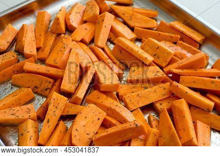 Sweet Potato Cut In Pieces And Covered With Oil And Herbs. Cooking Vegetables Macro Photo With Selec
