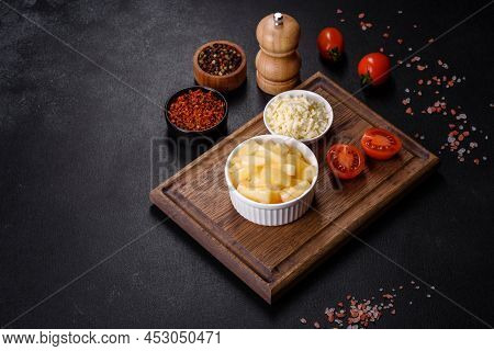 Canned Pineapple Chunks In A White Bowl On A Dark Concrete Background
