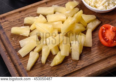 Canned Pineapple Chunks In A White Bowl On A Dark Concrete Background
