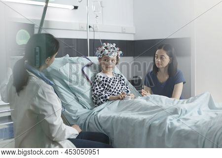 Clinic Pediatric Expert Checking Eeg Scan Results Of Sick Girl While In Pediatric Ward Consultation 