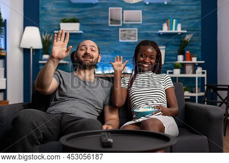 Pov Of Happy Smiling Man And Woman Waving At Webcam In A Videocall Conference While Being At Home In