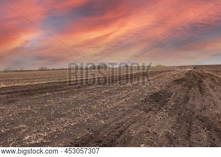 Plowed Field And Blue Sky In Sunset