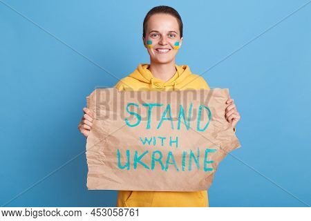 Image Of Smiling Positive Woman On Protest Against Russia Invasion Of Ukraine, Holding Placard With 