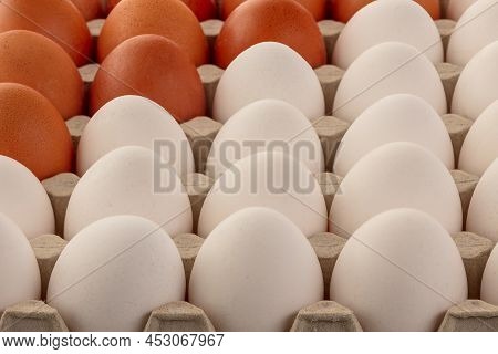 Chicken Eggs Brown And White In A Tray. Top View From An Angle.