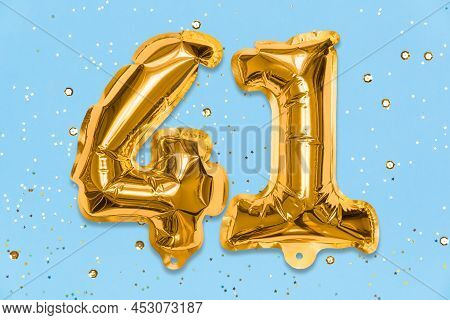 The Number Of The Balloon Made Of Golden Foil, The Number Forty-one On A Blue Background With Sequin