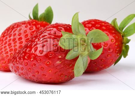 Macroshot Of Fresh Red Strawberries, Light Background, Front View