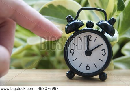 Hand Pointing Alarm Clock That Points At 2pm. Copy Space