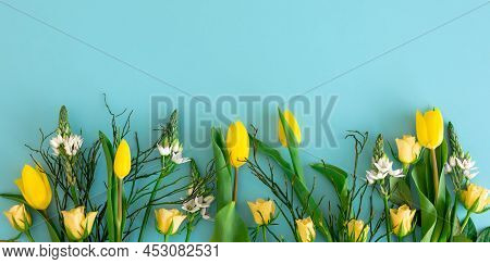 Yellow Spring Flowers On Blue Background, Flat Lay, Spring Concept.