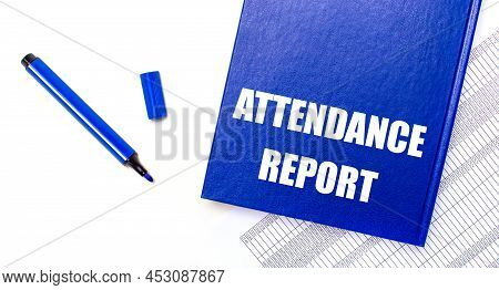 On A White Background Reports, A Blue Pen And A Blue Notebook With The Text Attendance Report. Busin