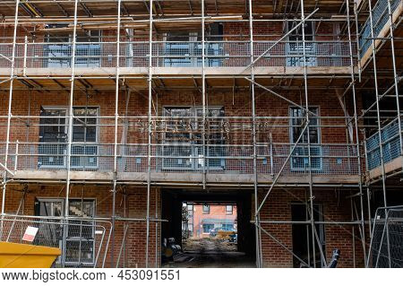 New Build Residential Multistorey Appartment Building Made Of Brick And Concrete Block, With Scaffol